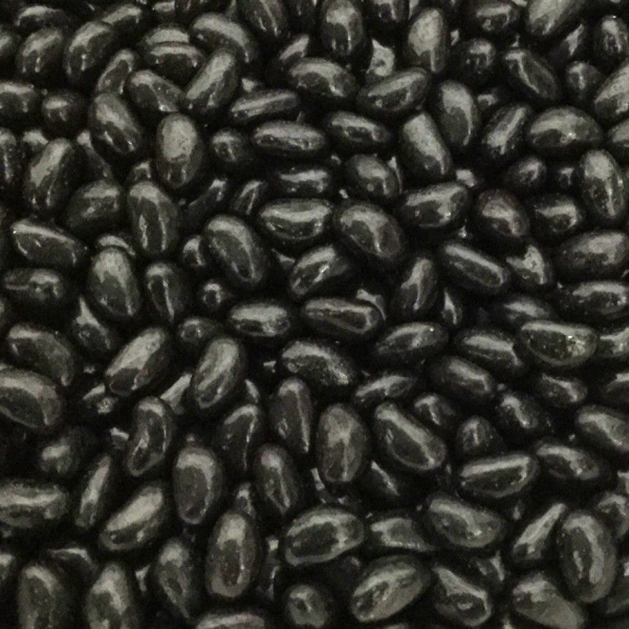 A pile of glossy black aniseed flavored single color jelly beans