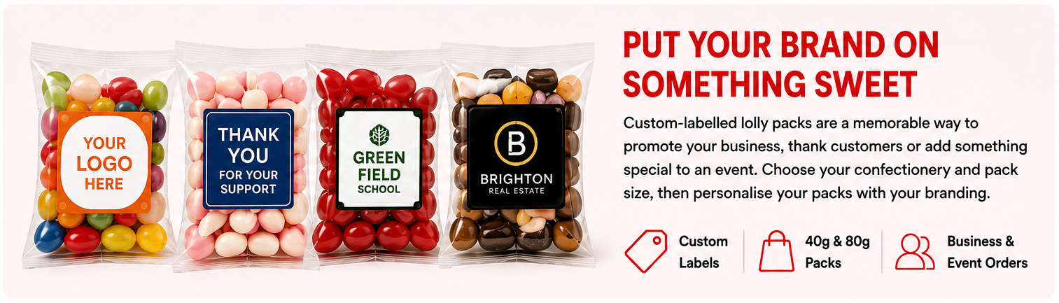 Four custom lollipops in colorful candy shells inside clear packaging, displayed on a white background with promotional text on the right. The lollipops include pink, red, brown, black, and white candy, and the labels show customizable options like 'YOUR LOGO HERE', 'THANK YOU FOR YOUR SUPPORT', 'GREEN FIELD SCHOOL', and 'BRIGHTON REAL ESTATE'.