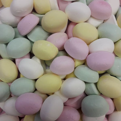 A colorful collection of dome shaped yellow pink and green assorted puff grained marshmallow lollies