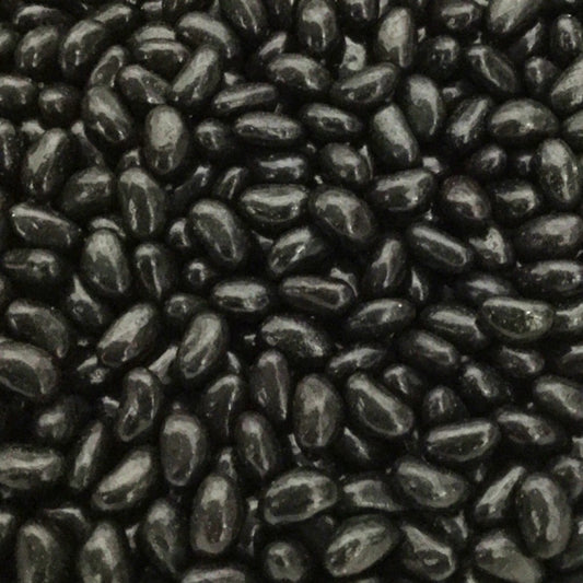 A pile of glossy black aniseed flavored single color jelly beans
