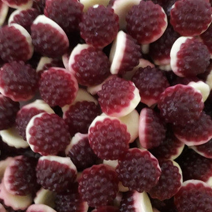 A pile of dual layered red and white dome shaped boysenberries and cream gummy lollies