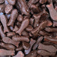 A pile of classic bite sized raspberry chewy fish lollies coated in a smooth milk chocolate layer