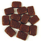 Pile of classic bite sized yellow pineapple flavored chewy centers covered in a smooth milk chocolate coating