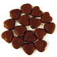Red strawberry flavored chew heart lollies coated in smooth milk chocolate