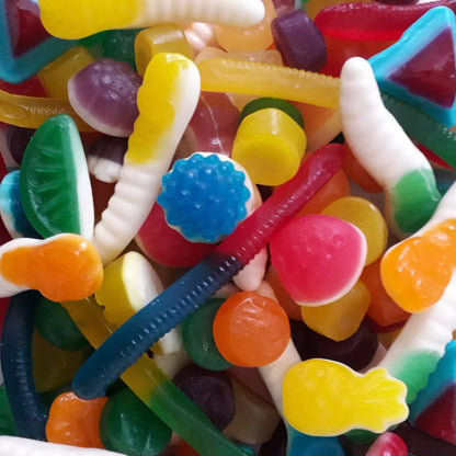A vibrant assortment of various colorful gummy lolly shapes and fruit flavors mixed together