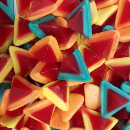 A pile of Rainbow Multi Volcanoes showing vibrant pyramid shaped aerated gummy lollies with red sour tops