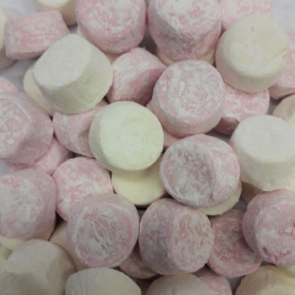 A pile of soft pink and white pillowy marshmallow lollies in vanilla and raspberry flavors