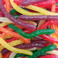 A vibrant mix of multi-colored Rainbow Snakes featuring long, stretchy snake-shaped gummy candies in six distinct fruit flavors.