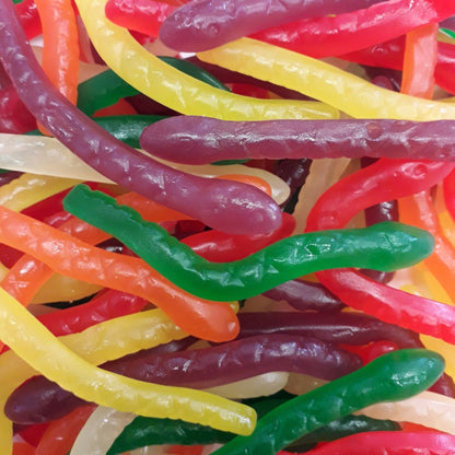 A vibrant mix of multi-colored Rainbow Snakes featuring long, stretchy snake-shaped gummy candies in six distinct fruit flavors.