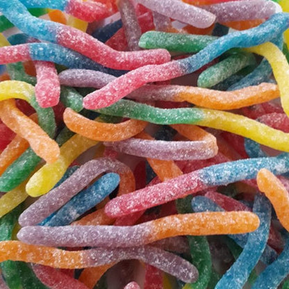 A colorful assortment of Rainbow Sour Gloworms featuring vibrant worm-shaped gummy candies dusted with a fine sour sugar coating.